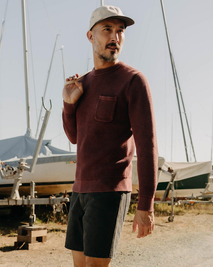 fit model walking wearing The Crawford Crew Sweater in Dried Cherry