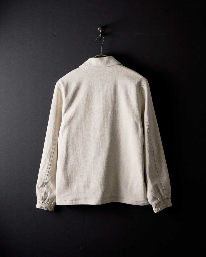 editorial image of the back of The Crew Jacket in Seeded Natural Sashiko hanging