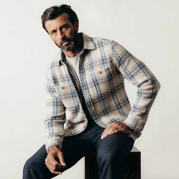fit model sitting wearing The Cutter Overshirt in Sandbar Plaid