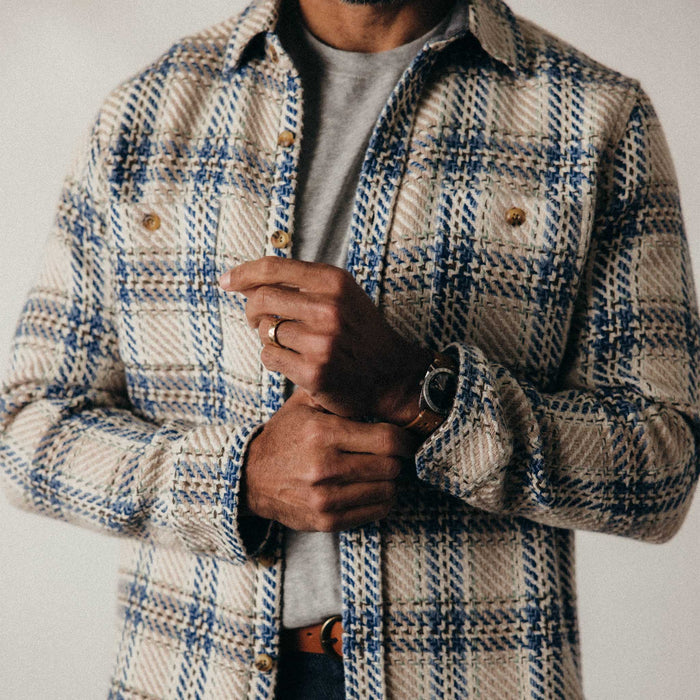 fit model adjusting the cuffs on The Cutter Overshirt in Sandbar Plaid