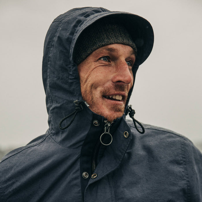 fit model wearing The Dalton Jacket in Navy on a ferry, smiling, looking right