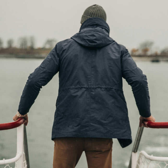 fit model wearing The Dalton Jacket in Navy on a ferry, back shot