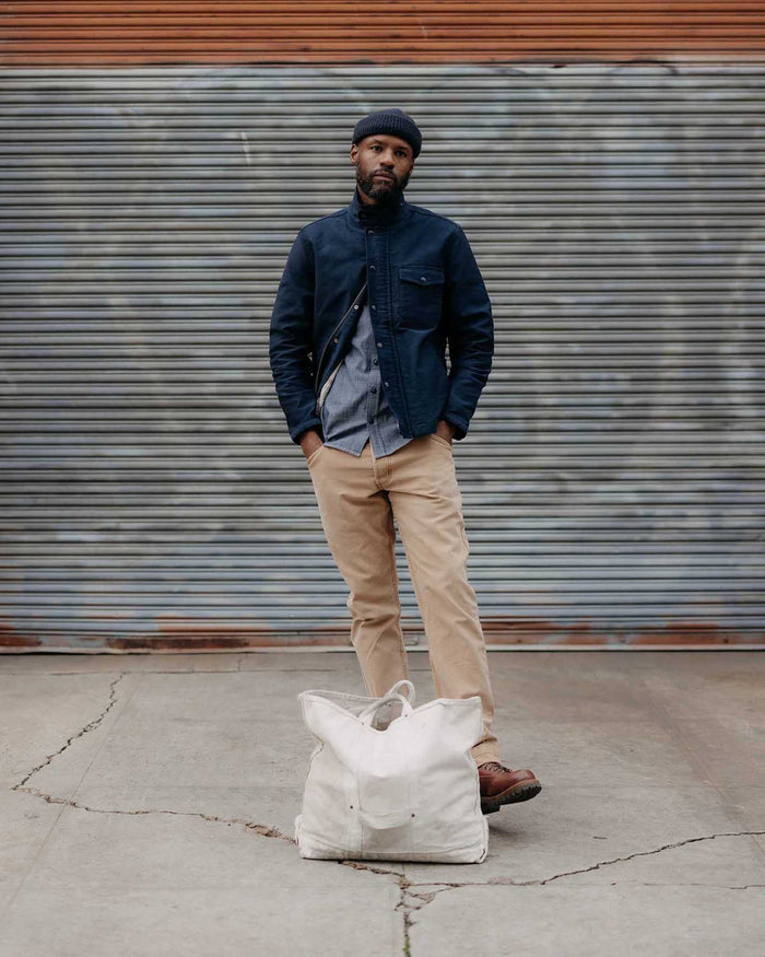 fit model standing wearing The Deck Jacket in Dark Navy Bedford Cord
