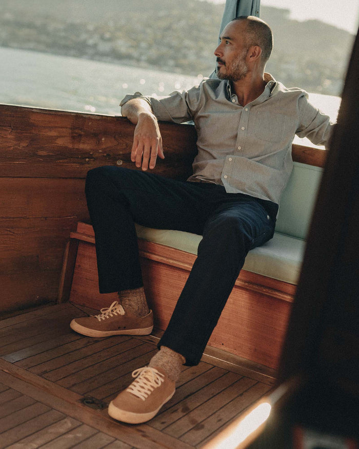 fit model sitting wearing The Deck Pant in Dark Navy Bedford Cord