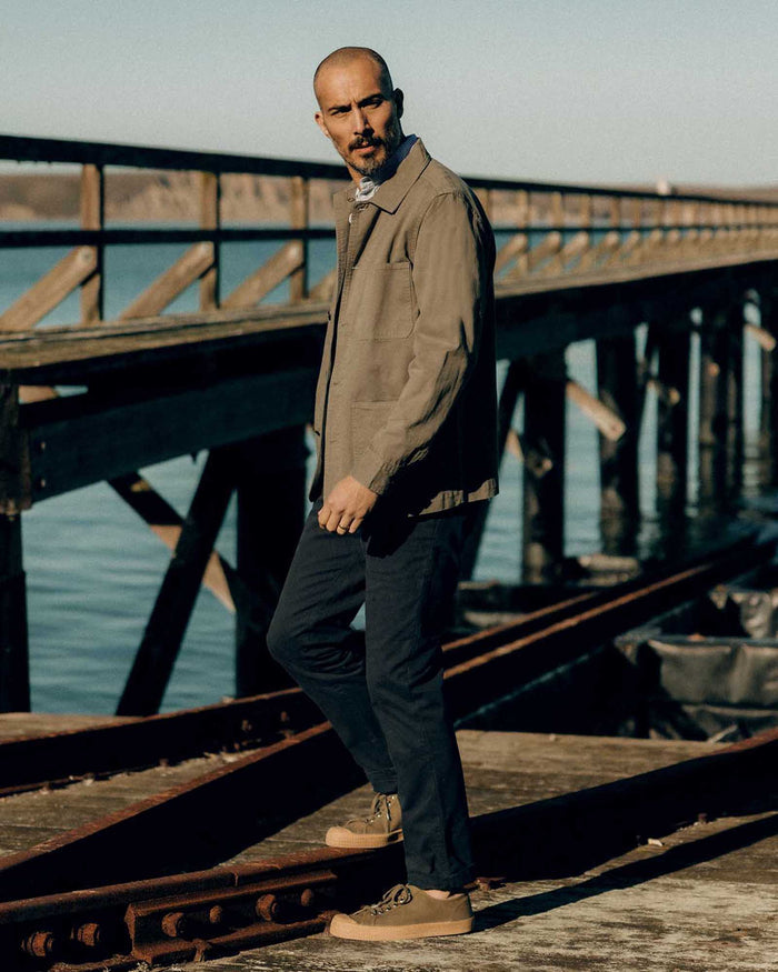 fit model walking wearing The Democratic Foundation Pant in Organic Navy