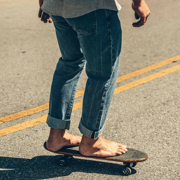 The fit model showing the back of the denim skateboarding in SF.