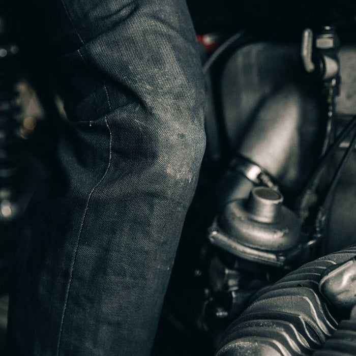 fit model wearing The Democratic Jean in Black Over-dye Selvage, knee close up