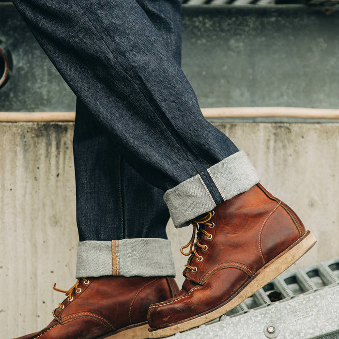 fit model wearing The Democratic Jean in Cone Mills Reserve Selvage, cuffed over boots