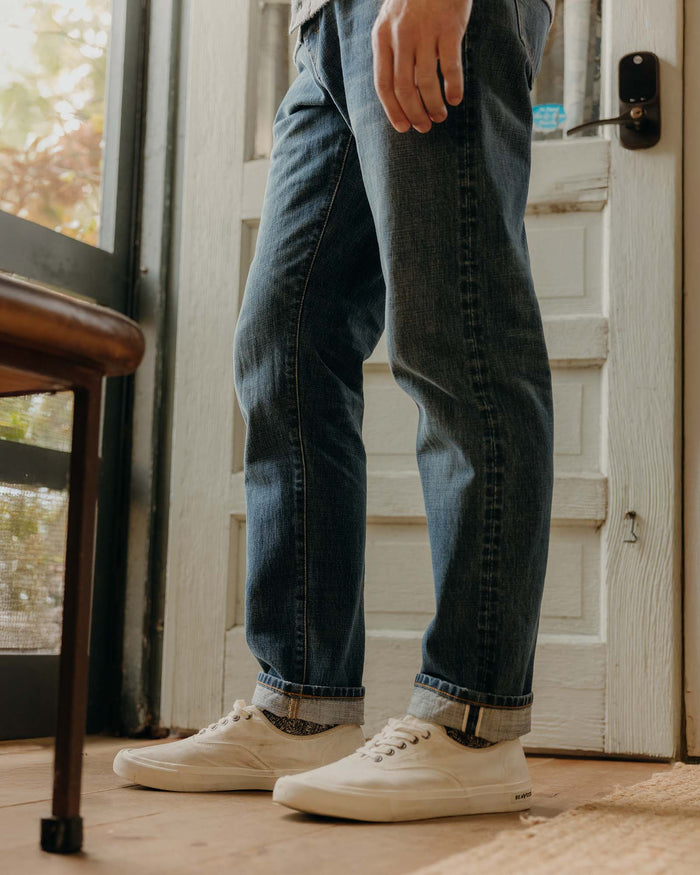 fit model walking wearing The Democratic Jean in Mid Wash Organic Selvedge