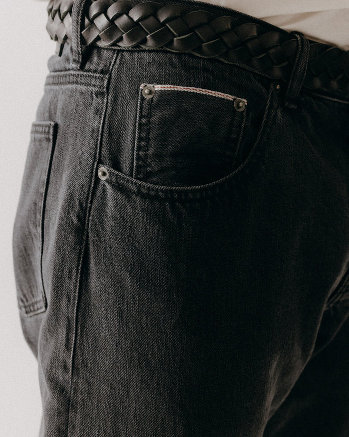 fit model showing off the pocket on The Democratic Jean in Washed Black Organic Slub Selvedge