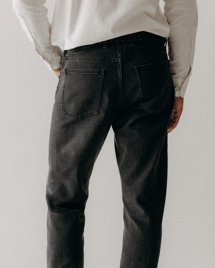 fit model showing off the back pocket on The Democratic Jean in Washed Black Organic Slub Selvedge