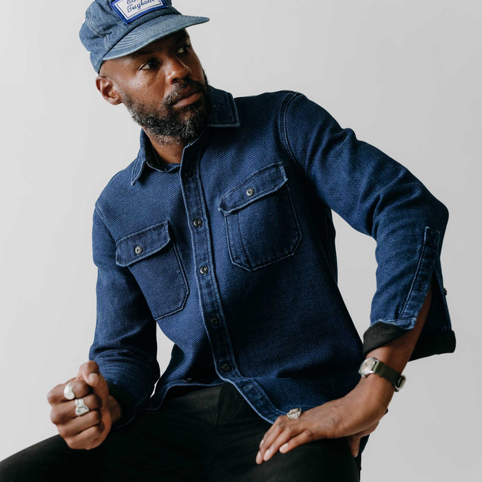 fit model standing by a tree wearing The Division Shirt in Indigo Twill