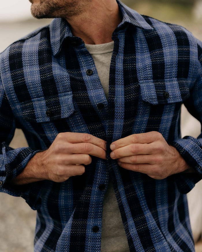 fit model with his shirt open wearing The Division Shirt in Rinsed Indigo Plaid