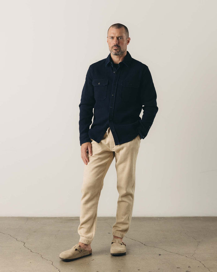 fit model sitting wearing The Division Shirt in Rinsed Indigo