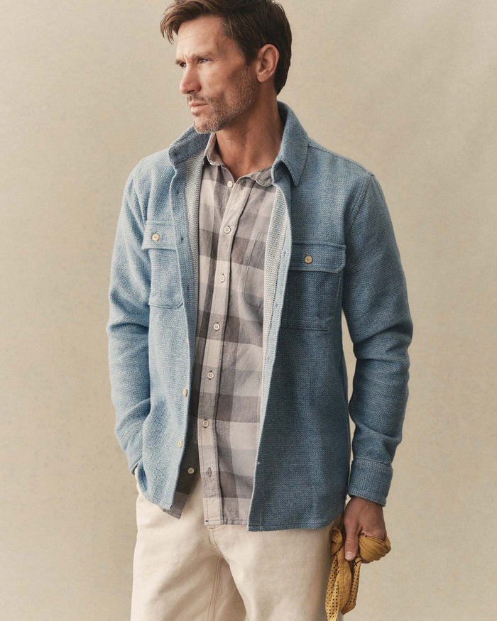 fit model sitting wearing The Division Shirt in Washed Indigo