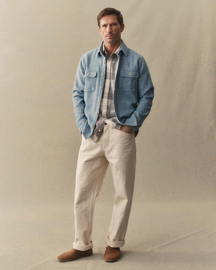 fit model adjusting sleeve on The Division Shirt in Washed Indigo