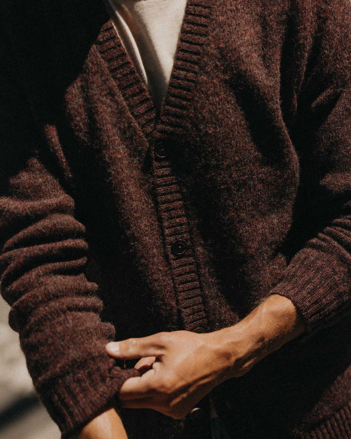 fit model adjusting the sleeves on The Eastmoor Cardigan in Heather Port Wool