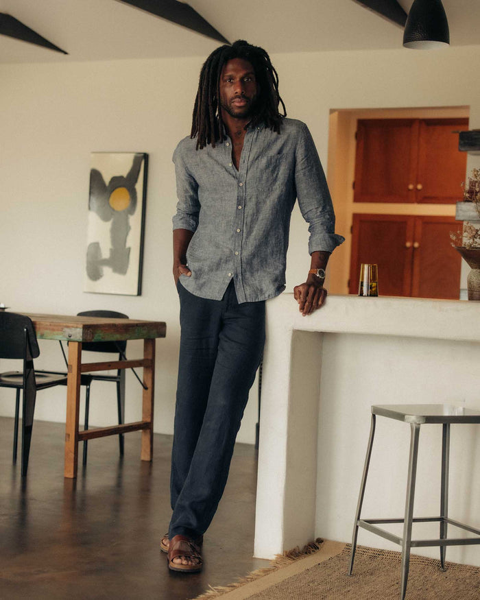 fit model leaning against a counter wearing The Easy Pant in Navy Linen