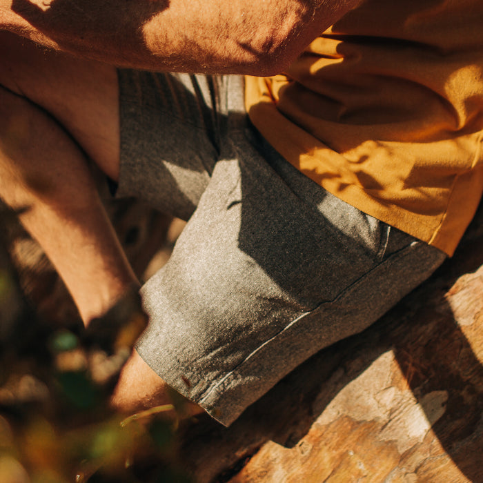 fit model sitting in The Easy Short in Charcoal Herringbone