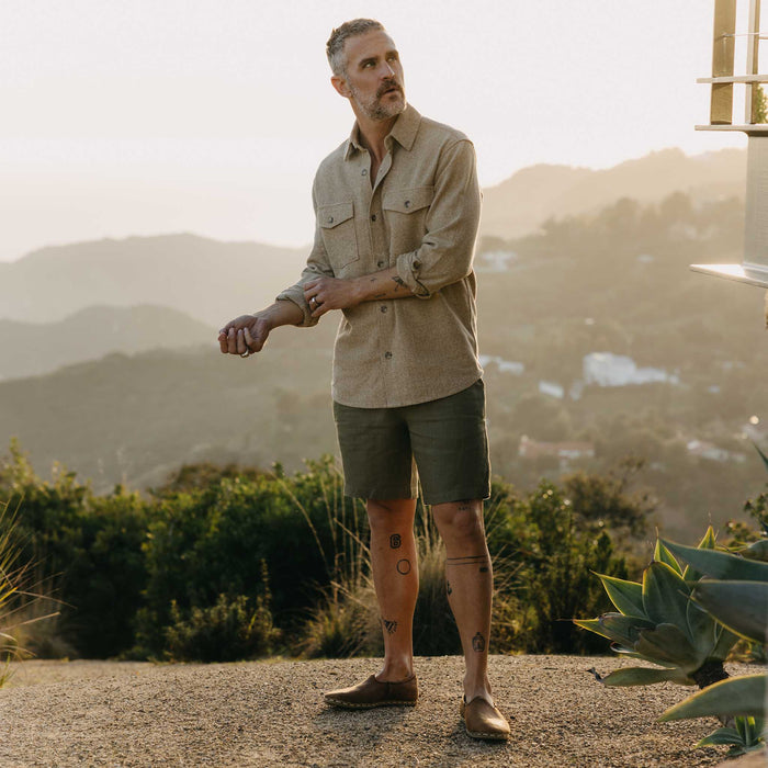fit model standing wearing The Easy Short in Olive Linen