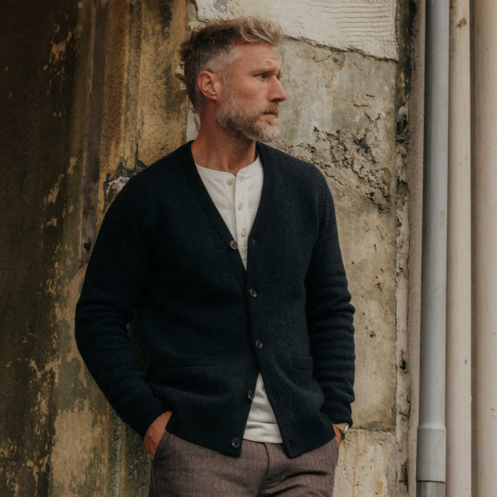 fit model posing in The Eddy Cardigan in Heather Marine Herringbone