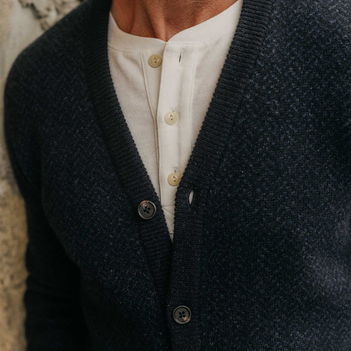 fit model showing off the texture on The Eddy Cardigan in Heather Marine Herringbone