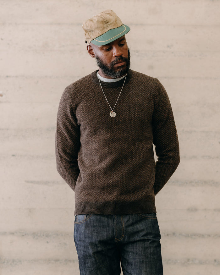 fit model sitting wearing The Eddy Crew in Coffee Herringbone