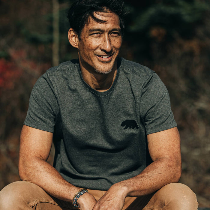 fit model wearingThe Embroidered Heavy Bag Tee in Grey Bear, sitting