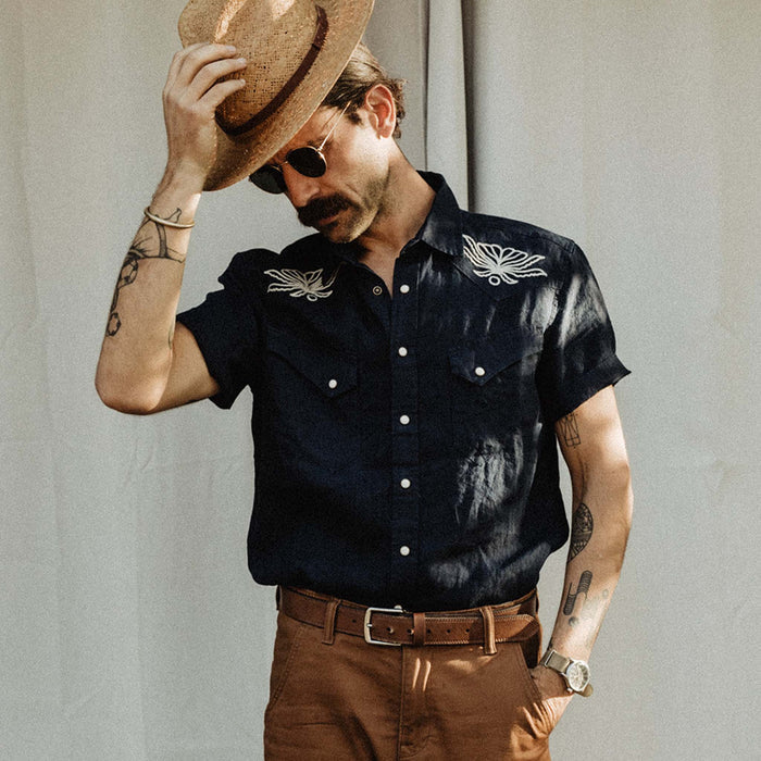fit model posing in The Embroidered Short Sleeve Western in Indigo Linen