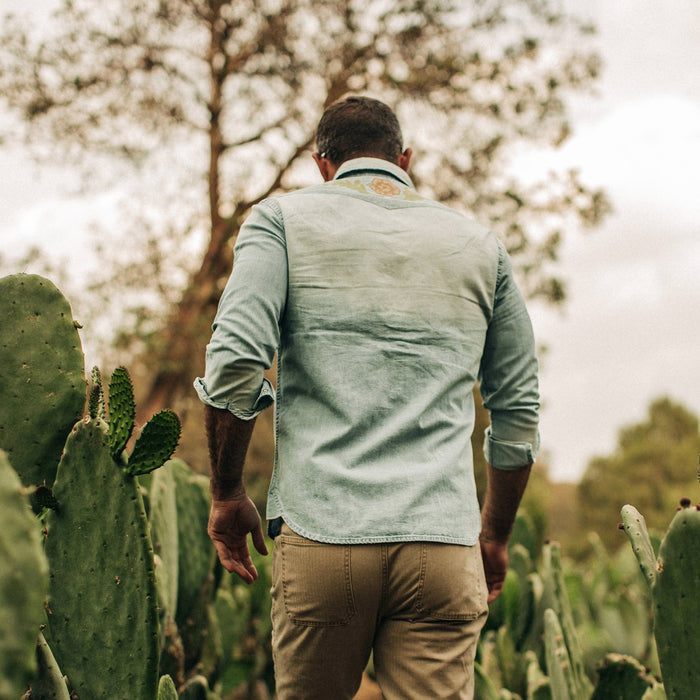 fit model wearing The Embroidered Western Shirt in Washed Denim, back shot