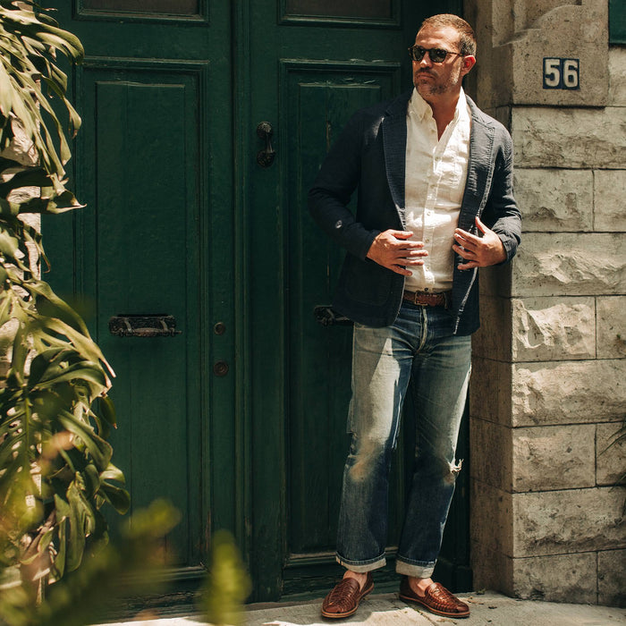 fit model wearing The Emerson Jacket in Navy Double Cloth, standing next to door
