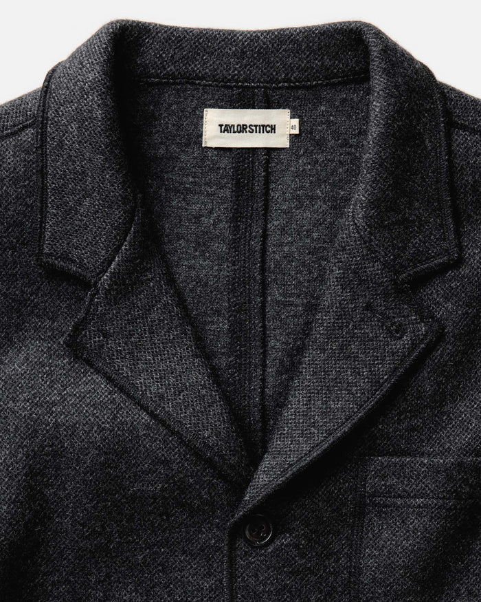 fit model standing in The Ridgewood Cardigan in Charcoal Birdseye Wool