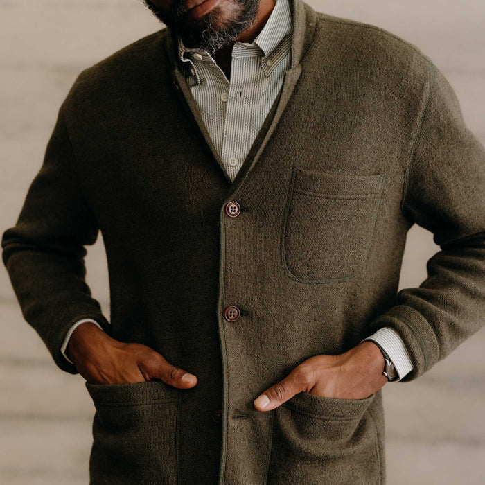 fit model with his hands in his pockets wearing The Evans Blazer in Forest Birdseye Wool