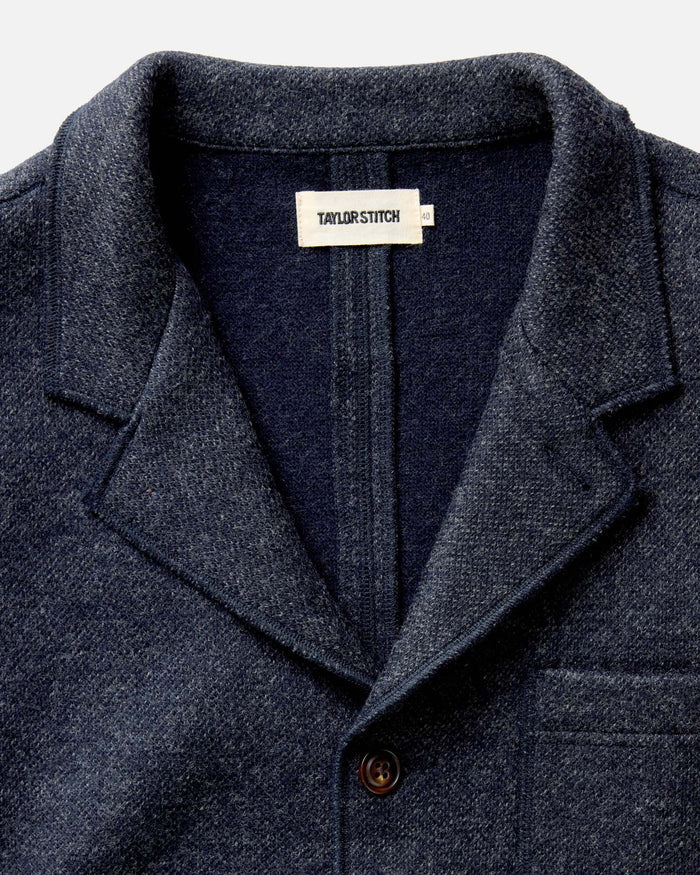 fit model standing by the doorway in The Ridgewood Cardigan in Navy Birdseye Wool