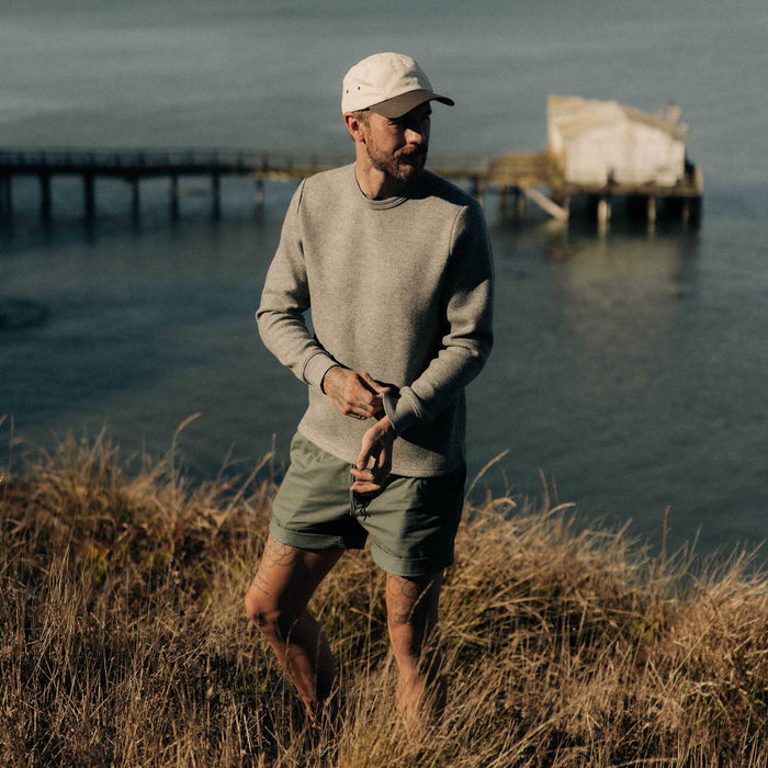 fit model adjusting the cuffs on The Evans Crew in Dark Ash Birdseye Wool