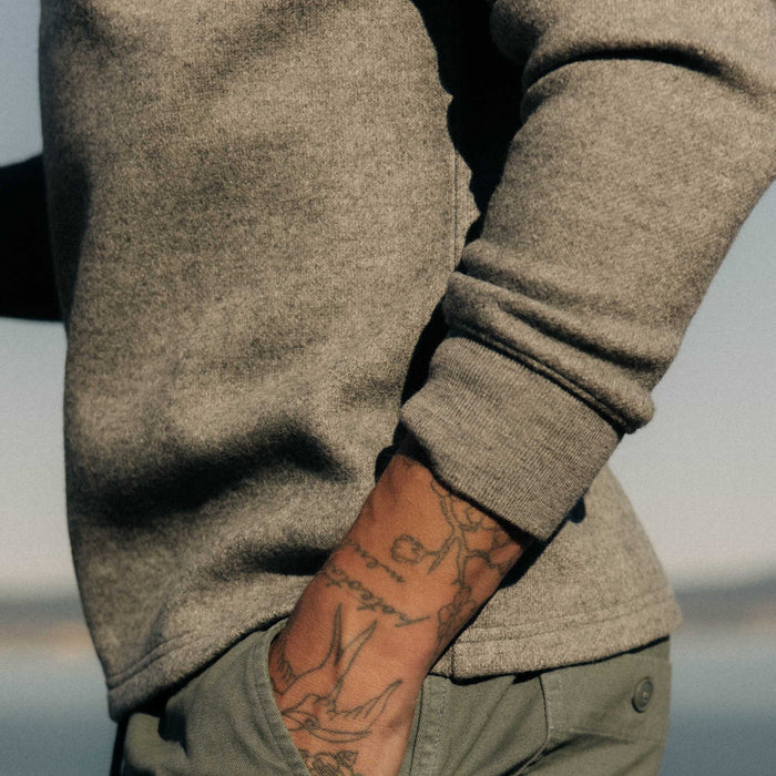 fit model with his hand in his pocket wearing The Evans Crew in Dark Ash Birdseye Wool