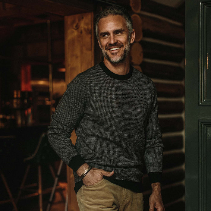 fit model wearing The Everett Sweater in Black Birdseye, smiling