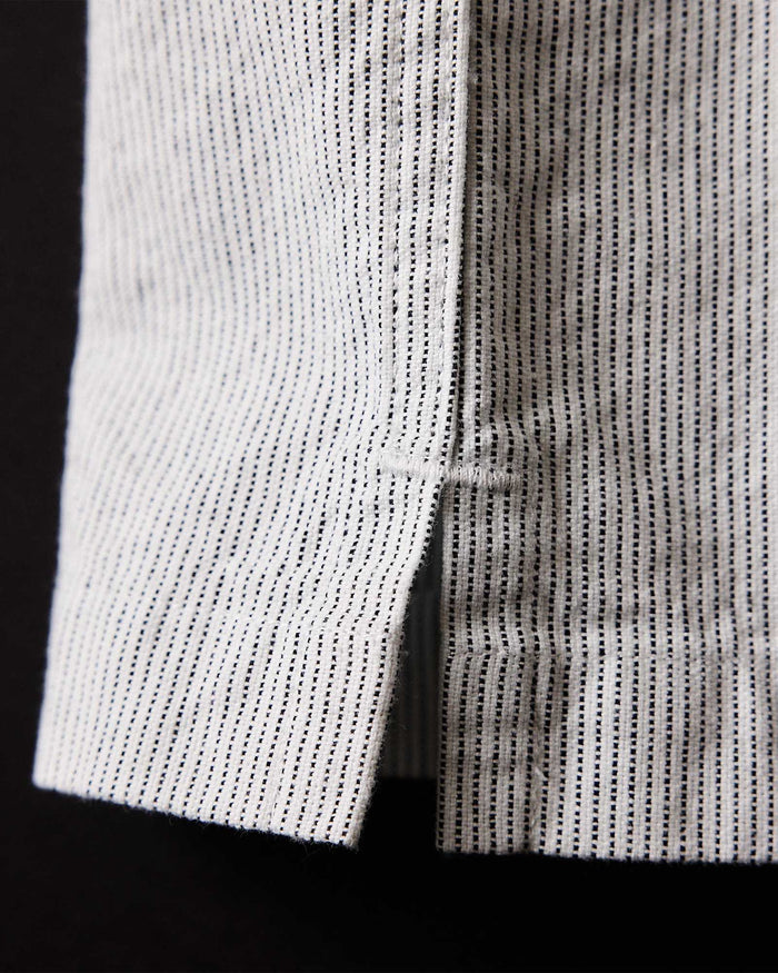 material shot of the bottom hem on The Exhaust Shirt in Natural Stripe