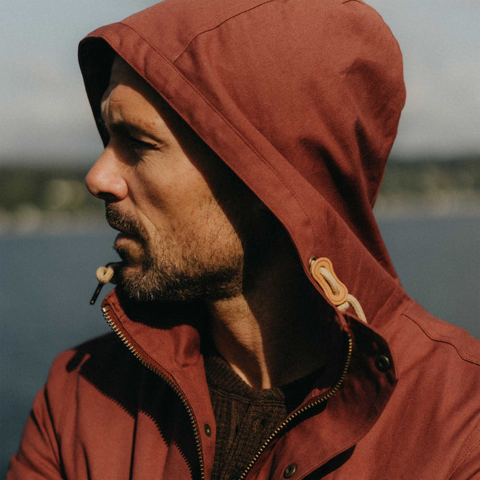 fit model with his hood on wearing The Explorer Jacket in Red Wine Dry Wax