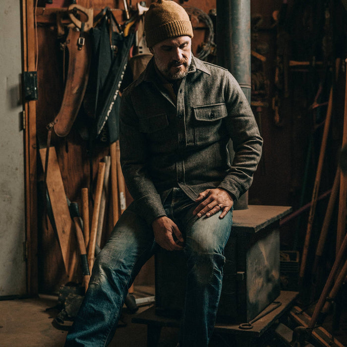 fit model wearingThe Explorer Shirt in Charcoal Herringbone, sitting