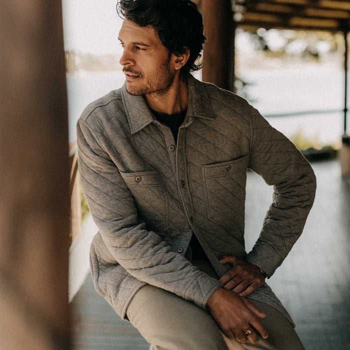 fit model sitting wearing The Fall Line Overshirt in Heather Ash Quilted Jersey