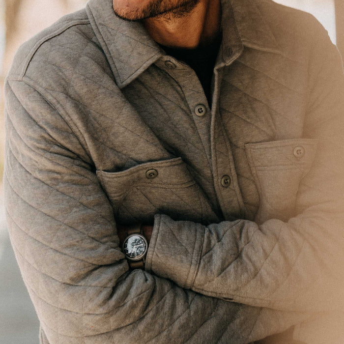 fit model with his arms crossed wearing The Fall Line Overshirt in Heather Ash Quilted Jersey