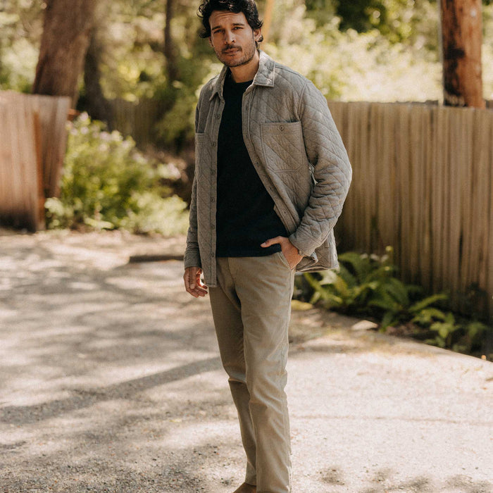 fit model sitting wearing The Fall Line Overshirt in Heather Ash Quilted Jersey