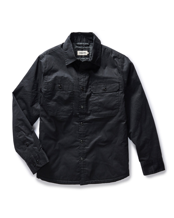flatlay of The Fender Waxed Canvas Jacket in Coal Dry Wax