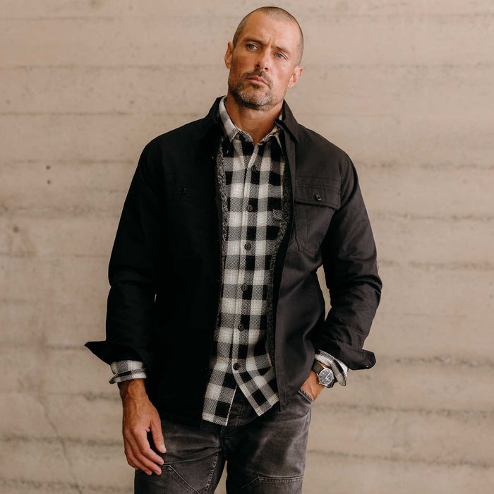 fit model wearing The Fender Waxed Canvas Jacket in Coal Dry Wax