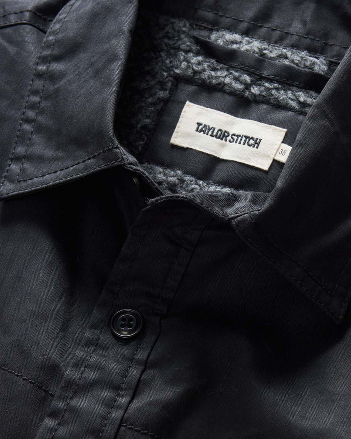 material shot of the collar on The Fender Jacket in Coal Dry Wax