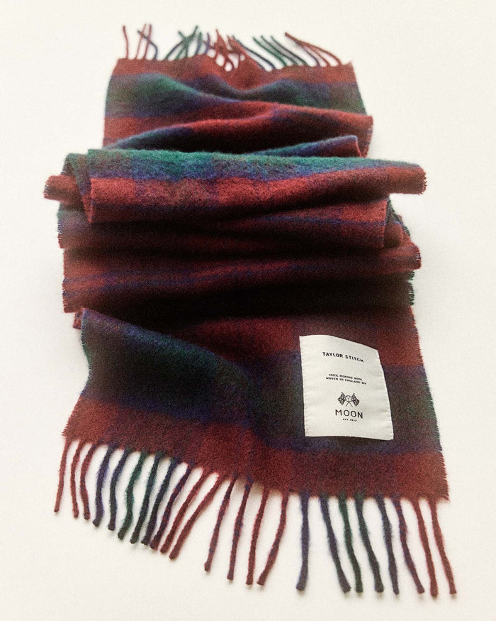 editorial flatlay of The Fireside Scarf in Currant Plaid