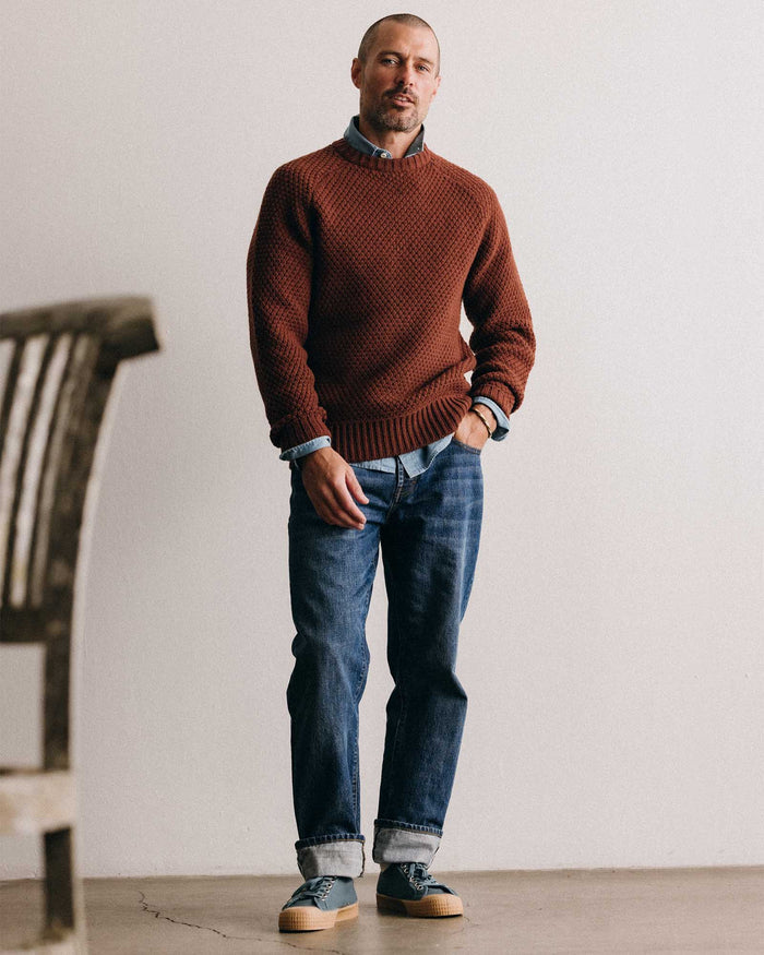 fit model posing in The Fisherman Sweater in Heather Brick Merino