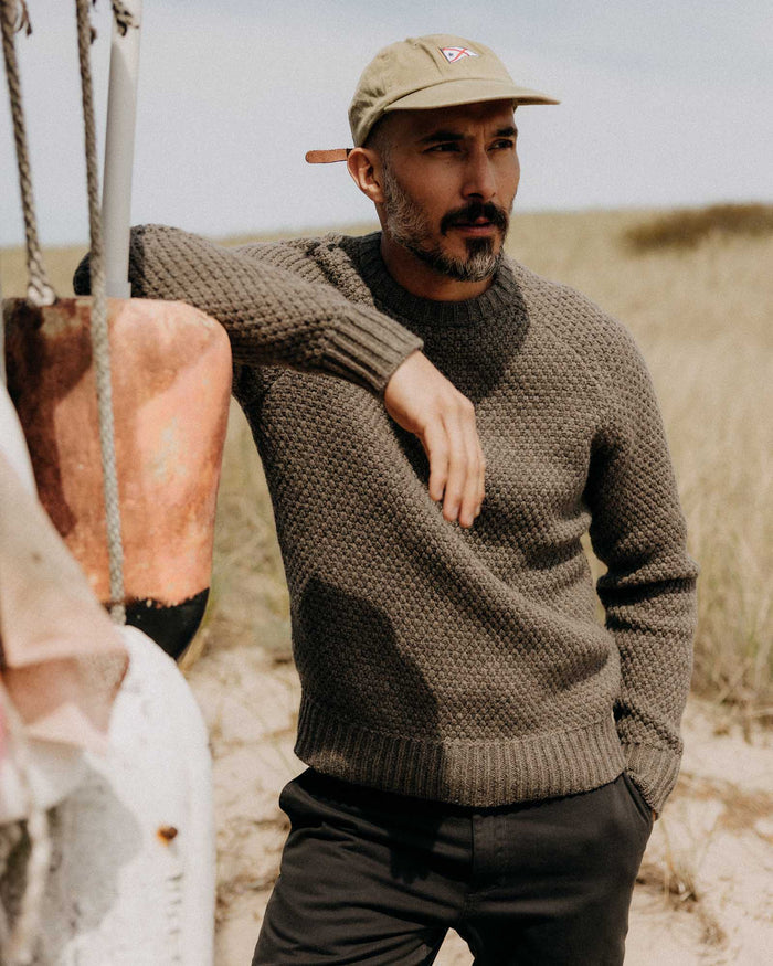 fit model adjusting the cuffs on The Fisherman Sweater in Taupe Merino