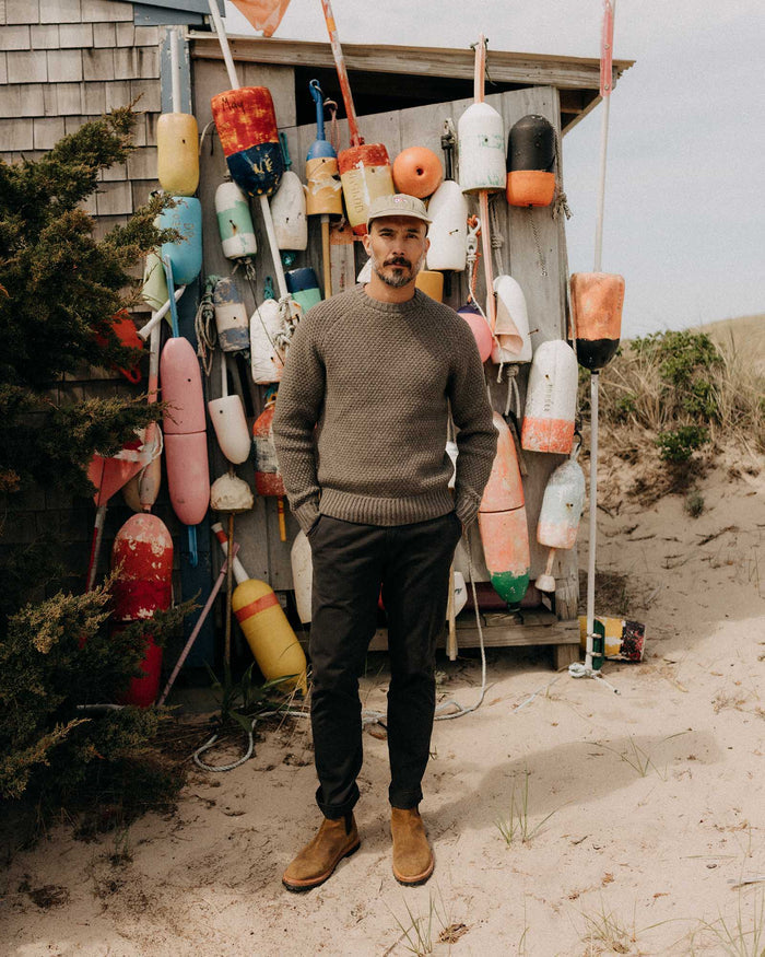 fit model with his hands in his pockets wearing The Fisherman Sweater in Taupe Merino